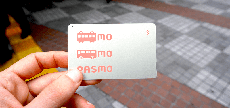 A person holding a pasmo IC card in their hand.