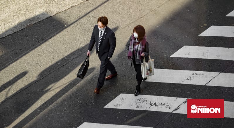 Two people crossing the road