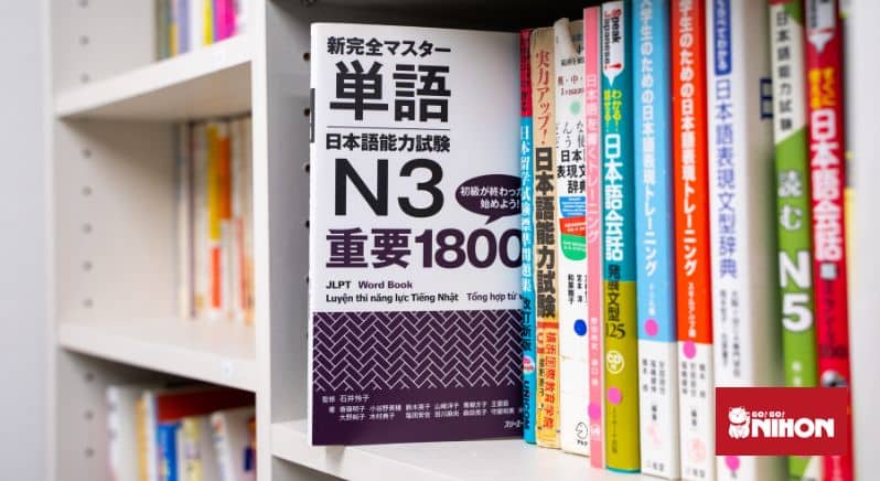 JLPT N3 study book pulled out on a shelf.