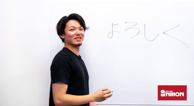 Youtuber TAKASHii from Japan writing Japanese slang on a whiteboard.