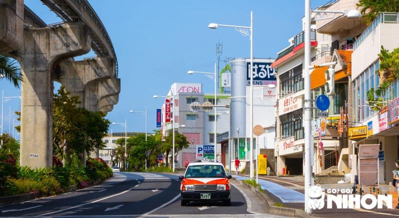 Japanese taxi on a road with skyline.